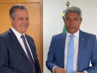 O governador Jerônimo Rodrigues e o ministro Rui Costa aparecem lado a lado, usando ternos, durante anúncio de investimentos do Novo PAC Seleções.