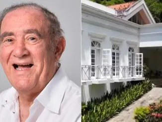 Vista externa de uma grande propriedade de luxo com jardins e estrutura imponente.