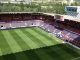 Vista do gramado e arquibancadas do Estádio Reyno de Navarra sob luz do dia.